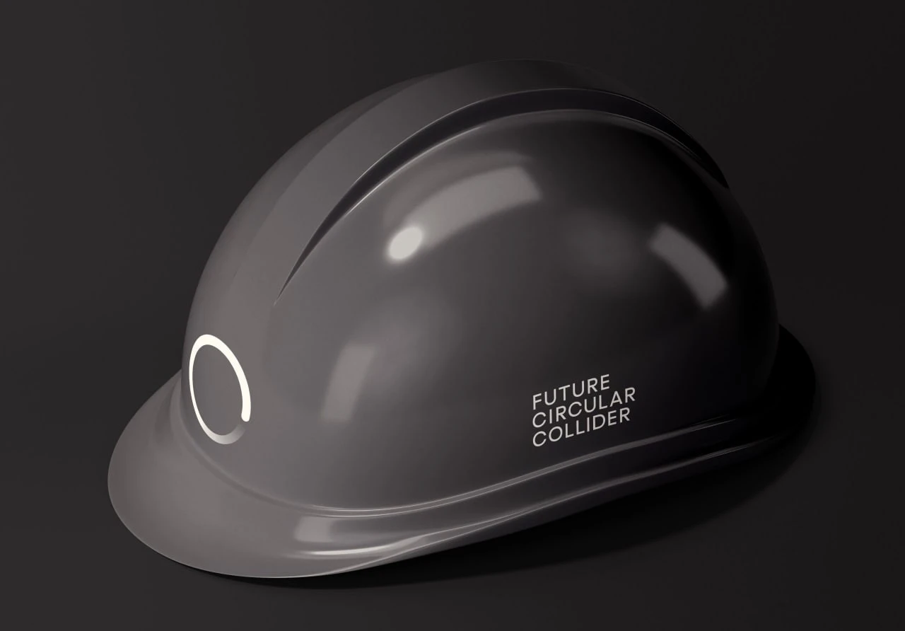 A dark hard hat bearing a pale open-circle mark and the Future Circular Collider name.
