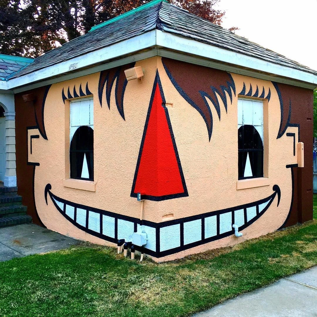 A building corner transformed into a smiling face by Tom Bob.