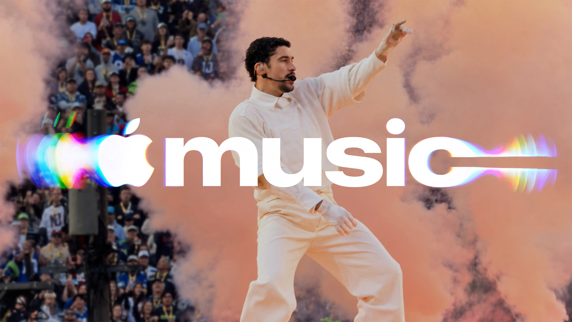 The new white Apple Music logo with coloured reflections over a concert photograph of a performer on stage.